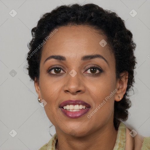 Joyful black young-adult female with long  brown hair and brown eyes