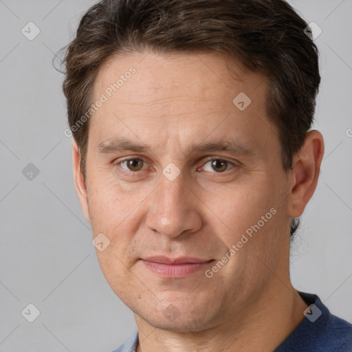 Joyful white adult male with short  brown hair and brown eyes