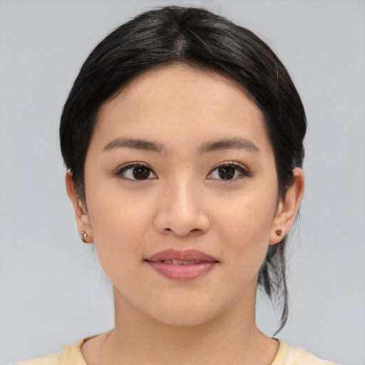 Joyful white young-adult female with medium  black hair and brown eyes