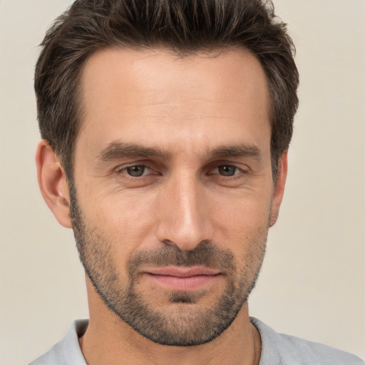 Joyful white adult male with short  brown hair and brown eyes