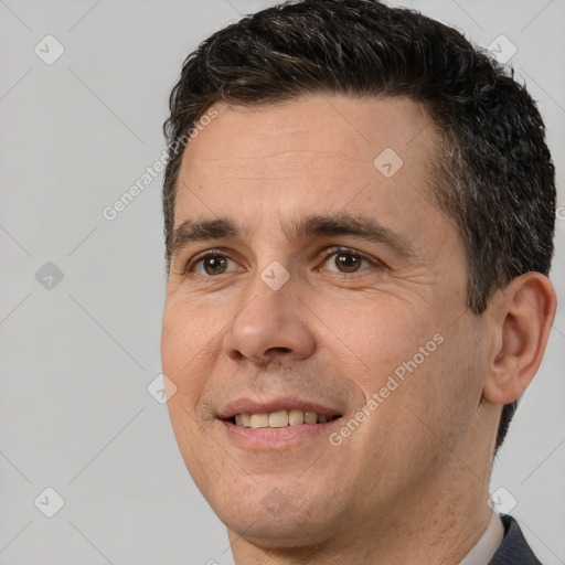 Joyful white adult male with short  brown hair and brown eyes