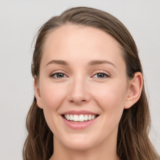 Joyful white young-adult female with long  brown hair and grey eyes