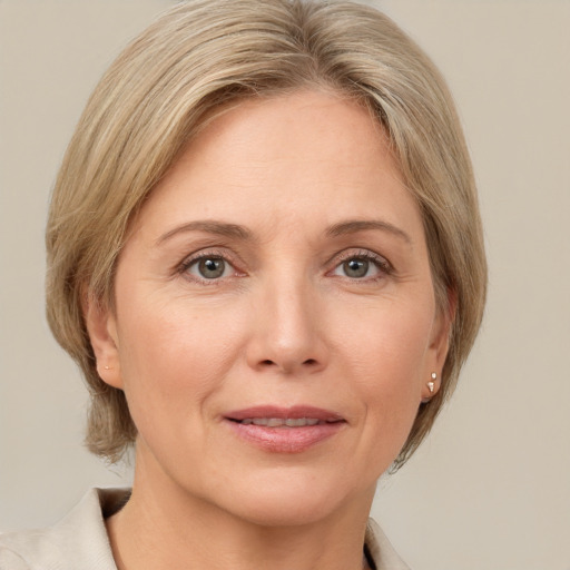 Joyful white adult female with medium  brown hair and grey eyes