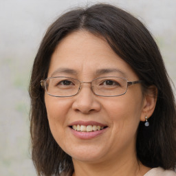 Joyful white adult female with long  brown hair and brown eyes