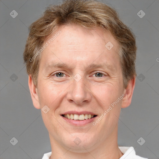 Joyful white adult male with short  brown hair and grey eyes