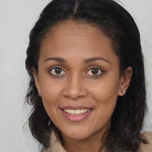 Joyful white young-adult female with long  brown hair and brown eyes