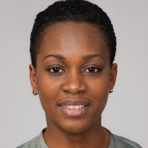 Joyful black young-adult female with short  black hair and brown eyes