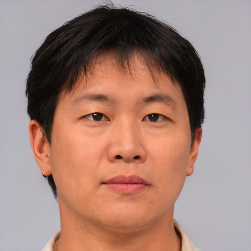 Neutral asian adult male with short  brown hair and brown eyes