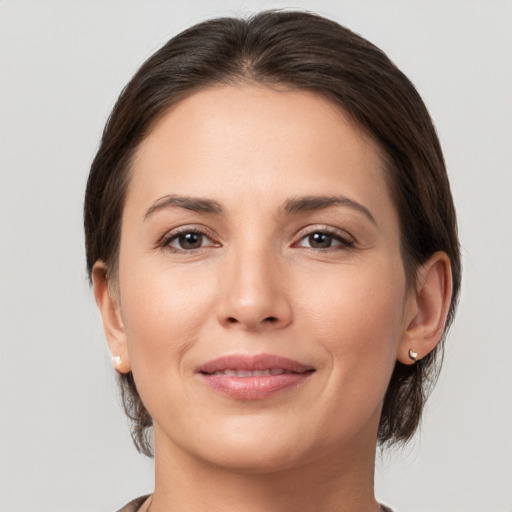 Joyful white young-adult female with medium  brown hair and brown eyes