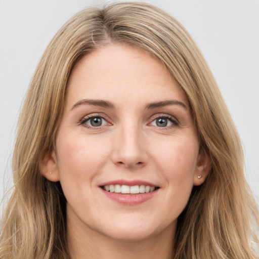 Joyful white young-adult female with long  brown hair and grey eyes