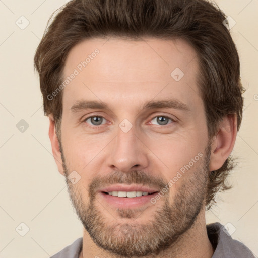 Joyful white adult male with short  brown hair and brown eyes