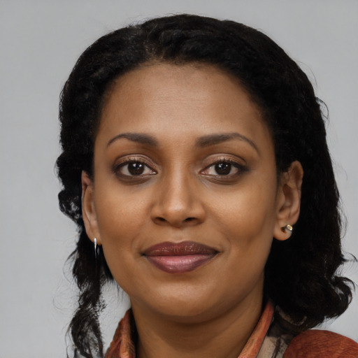 Joyful black young-adult female with medium  black hair and brown eyes
