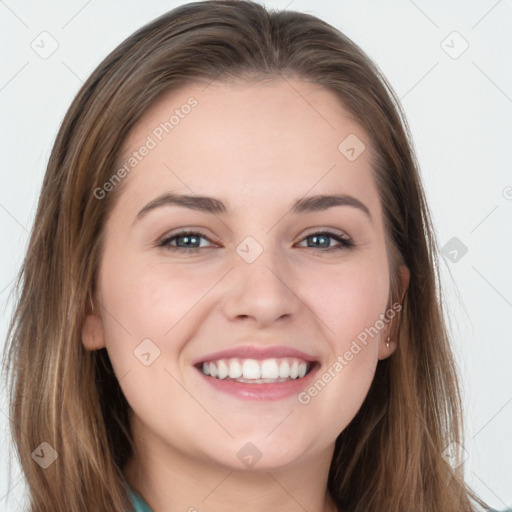 Joyful white young-adult female with long  brown hair and blue eyes