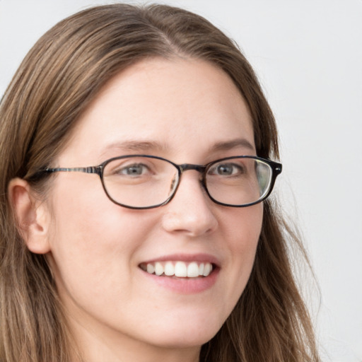 Joyful white young-adult female with long  brown hair and blue eyes