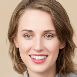 Joyful white young-adult female with medium  brown hair and green eyes