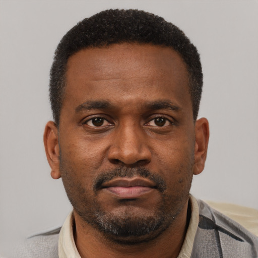 Neutral latino adult male with short  brown hair and brown eyes