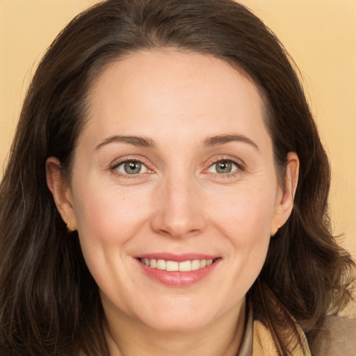 Joyful white adult female with long  brown hair and brown eyes