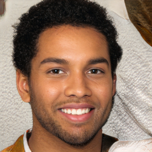 Joyful black young-adult male with short  brown hair and brown eyes