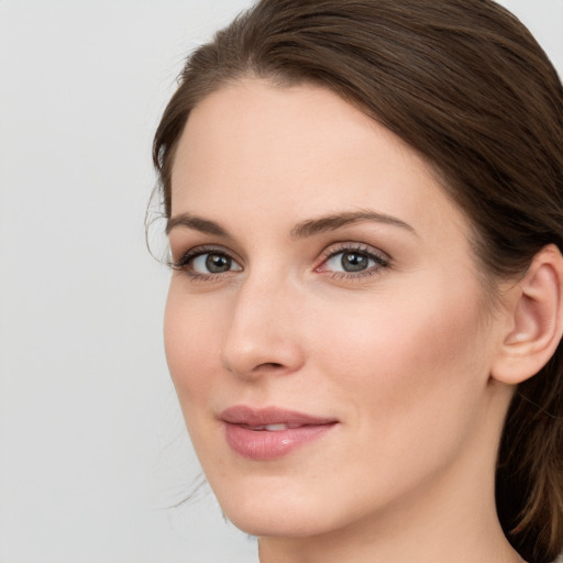 Joyful white young-adult female with long  brown hair and blue eyes