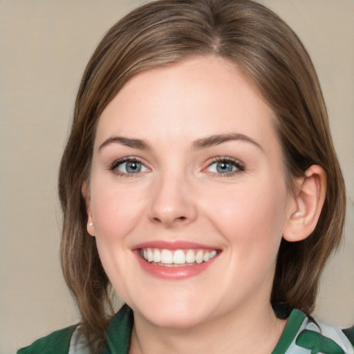 Joyful white young-adult female with medium  brown hair and green eyes