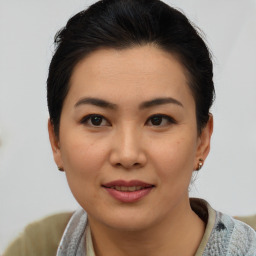 Joyful asian young-adult female with short  brown hair and brown eyes