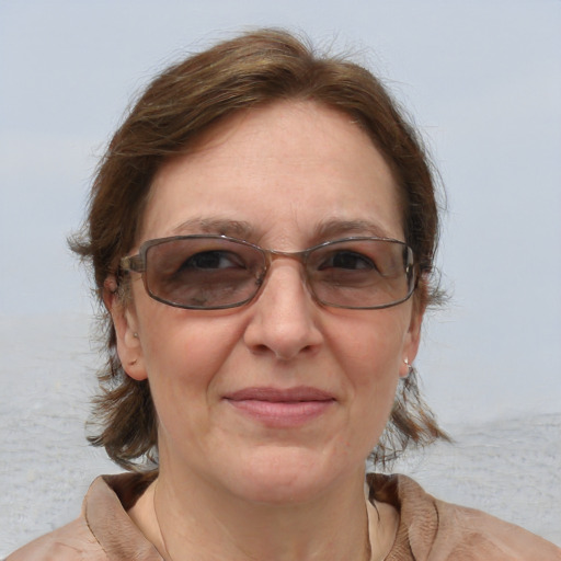 Joyful white adult female with medium  brown hair and grey eyes