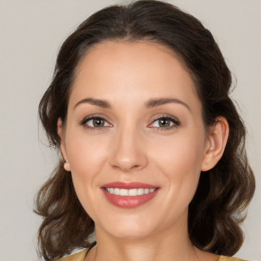 Joyful white young-adult female with medium  brown hair and brown eyes