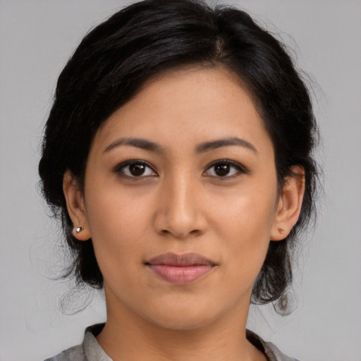 Joyful latino young-adult female with medium  black hair and brown eyes