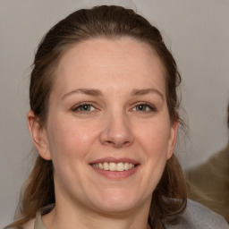 Joyful white adult female with medium  brown hair and grey eyes