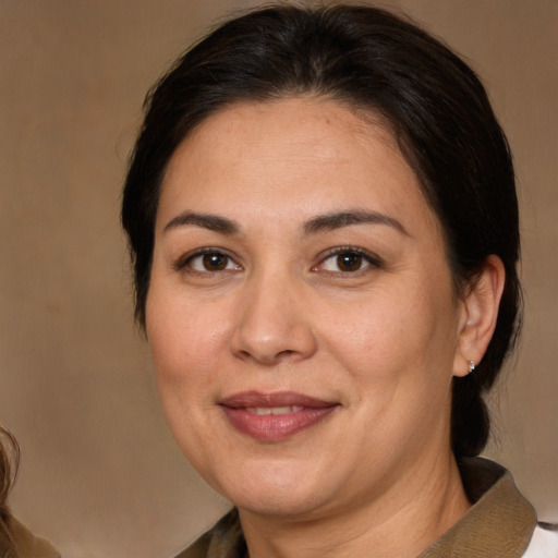 Joyful white adult female with medium  brown hair and brown eyes