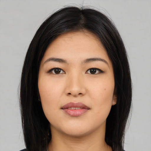 Joyful asian young-adult female with long  black hair and brown eyes