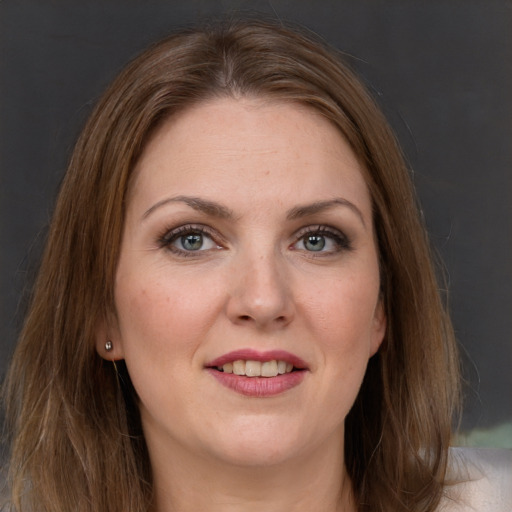 Joyful white young-adult female with long  brown hair and grey eyes