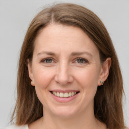 Joyful white adult female with medium  brown hair and grey eyes