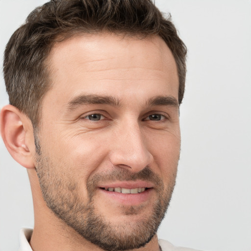 Joyful white adult male with short  brown hair and brown eyes