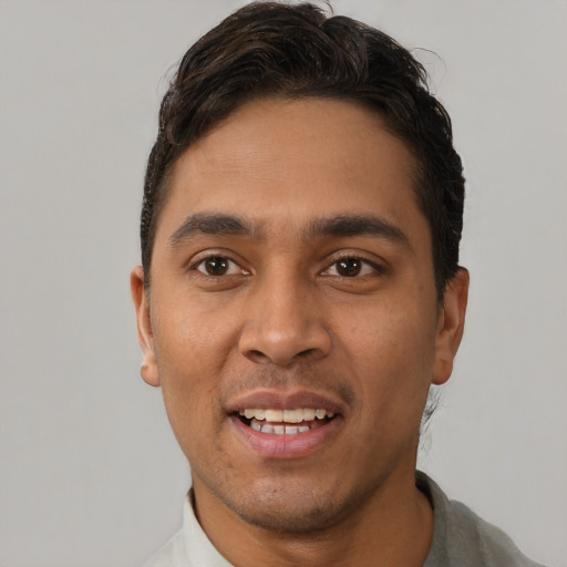 Joyful white young-adult male with short  black hair and brown eyes