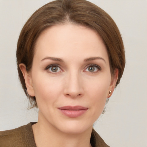 Joyful white young-adult female with medium  brown hair and grey eyes