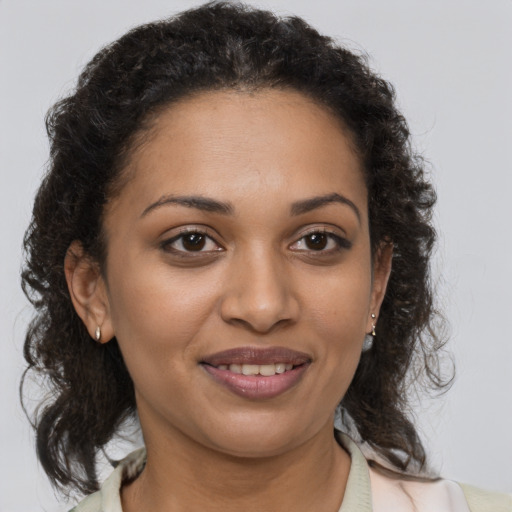Joyful black young-adult female with medium  brown hair and brown eyes