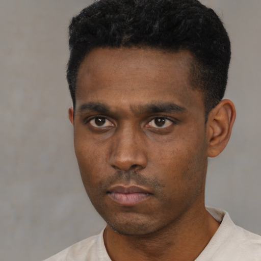 Neutral black young-adult male with short  black hair and brown eyes