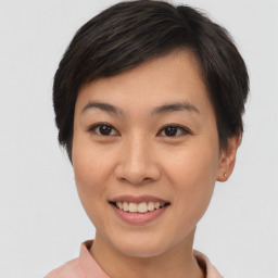 Joyful asian young-adult female with short  brown hair and brown eyes