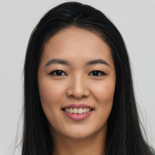 Joyful asian young-adult female with long  black hair and brown eyes