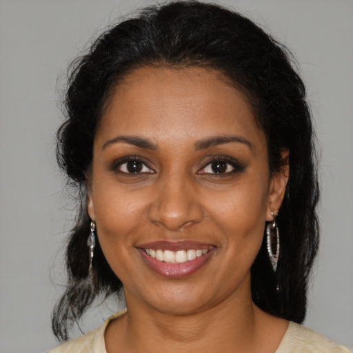 Joyful black young-adult female with medium  brown hair and brown eyes