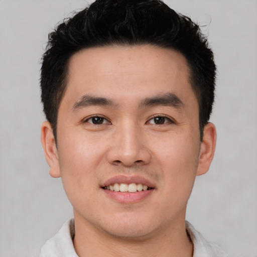 Joyful white young-adult male with short  black hair and brown eyes