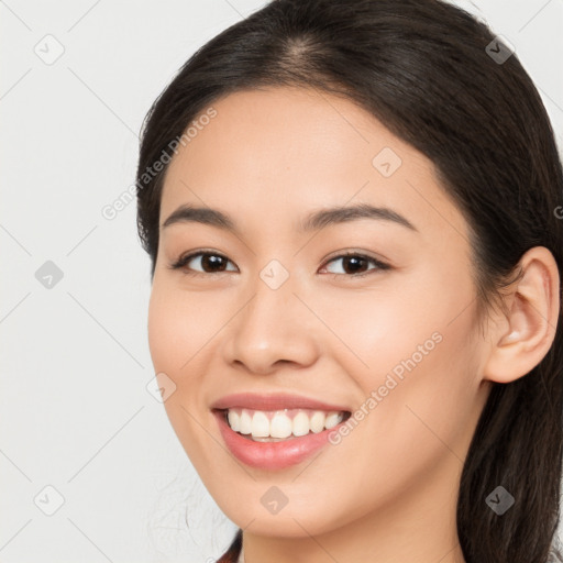 Joyful white young-adult female with long  brown hair and brown eyes