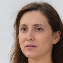 Joyful white adult female with long  brown hair and brown eyes