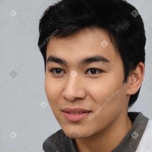 Joyful asian young-adult male with short  black hair and brown eyes