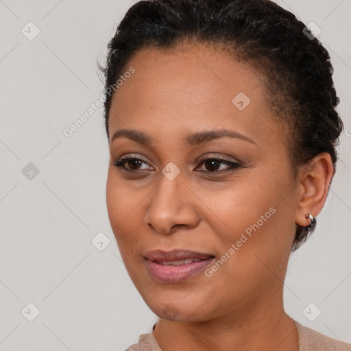 Joyful black young-adult female with short  brown hair and brown eyes