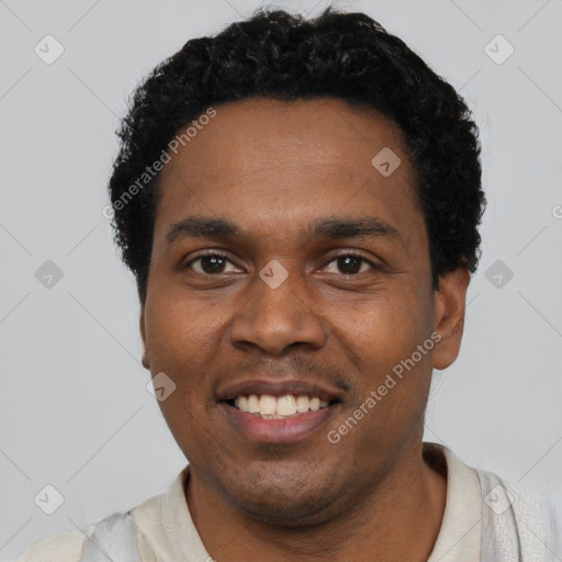 Joyful black young-adult male with short  black hair and brown eyes