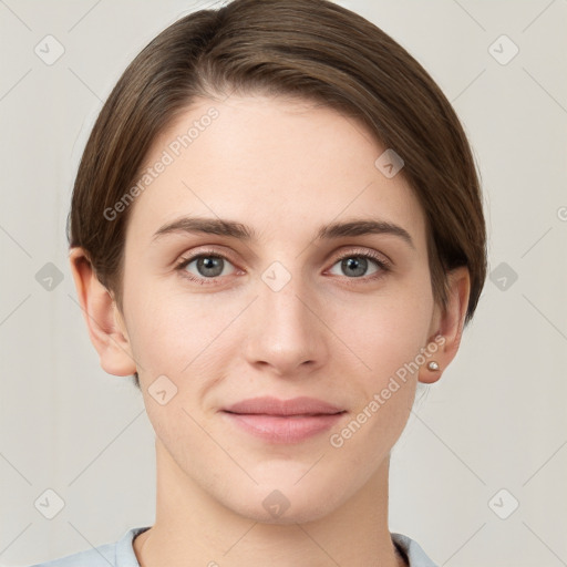 Joyful white young-adult female with short  brown hair and grey eyes