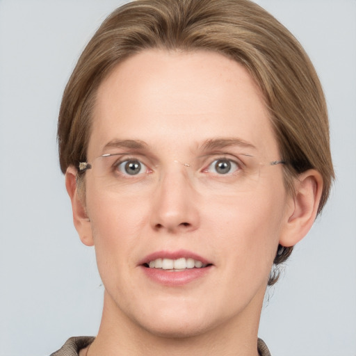 Joyful white adult female with medium  brown hair and grey eyes