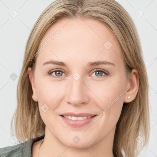 Joyful white young-adult female with medium  brown hair and blue eyes